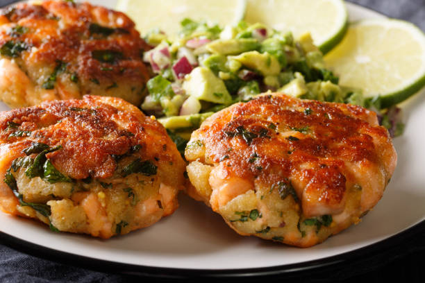 istock Salmon fritters served with avocado salsa and lime close-up. horizontal 1155945928