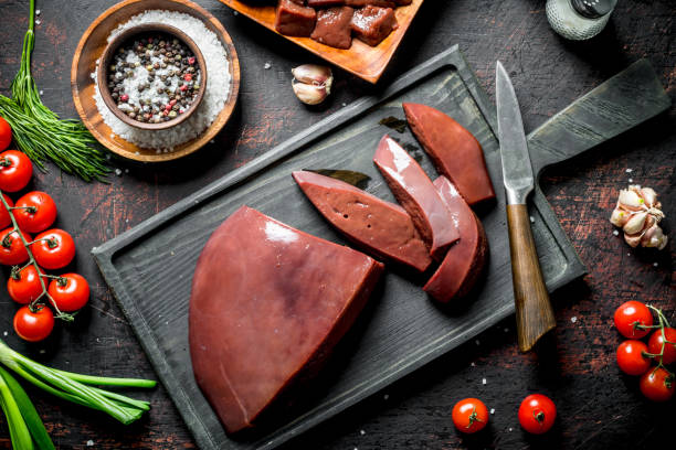 istock Sliced raw liver with tomatoes, herbs and spices. 1155947189