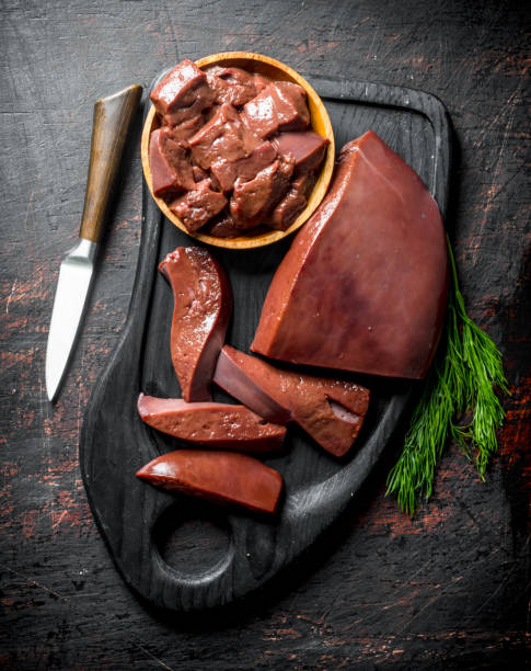 istock Pieces of raw liver on a cutting Board with dill. 1155947279