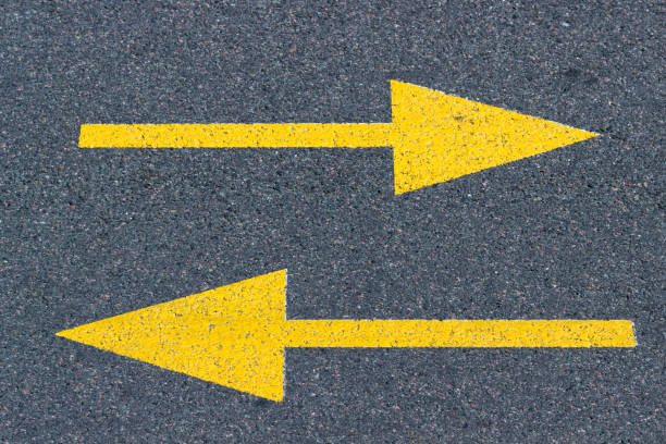 istock asphalt arrows, direction indicator, concept of choice or entanglement 1155948610