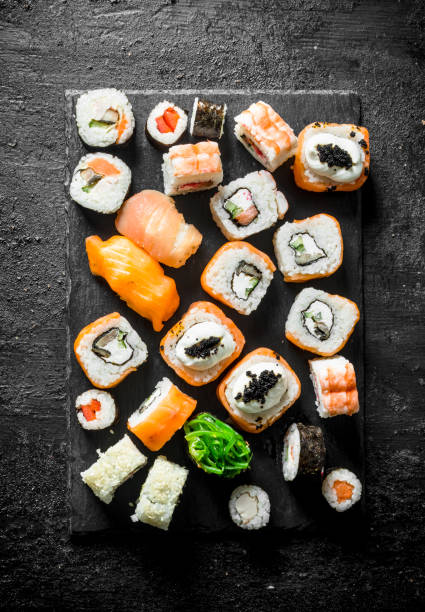 istock Set of different sushi rolls with salmon, chicken, shrimp and vegetables. 1155949471