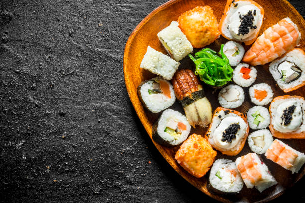 istock Different kinds of sushi rolls on the plate. 1155949803