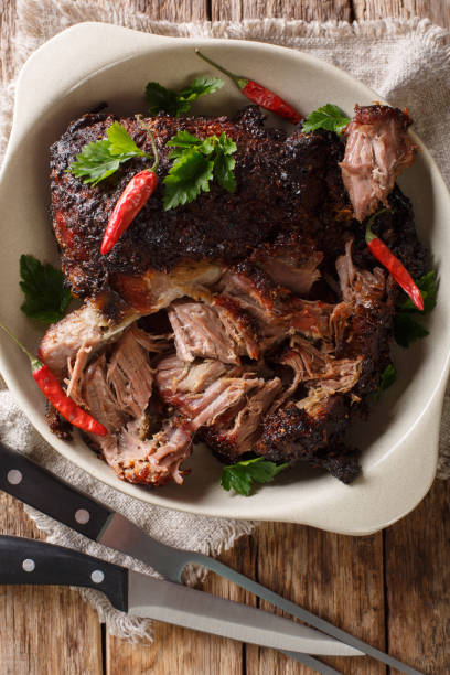istock Slowly cooked shredded pulled pork close-up on a plate. Vertical top view 1155949913