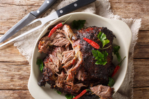 istock Delicious spicy slow shredded pulled pork closeup on a plate. horizontal top view 1155950965