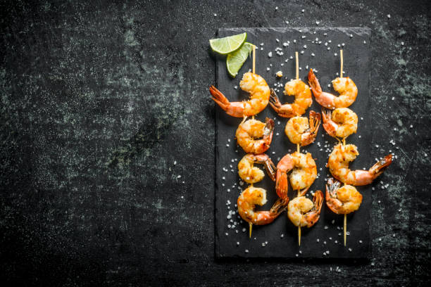 istock Fragrant shrimps grilled on a stone Board. 1155951053
