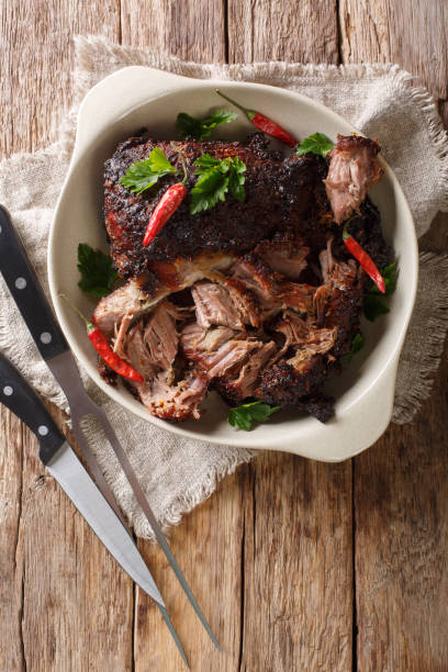 istock pernil asado slow cooked shredded pulled pork close-up on a plate. Vertical top view 1155951169