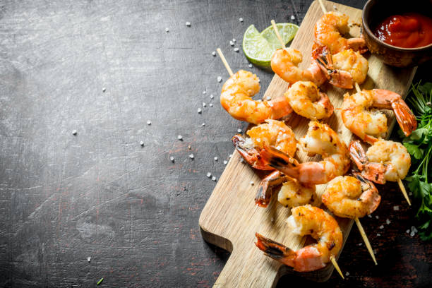 istock Fried shrimps on a cutting Board with sauce. 1155951248