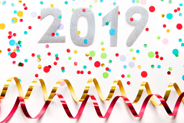 istock 2019 party background, confetti and paper streamers on white background. 1155952420