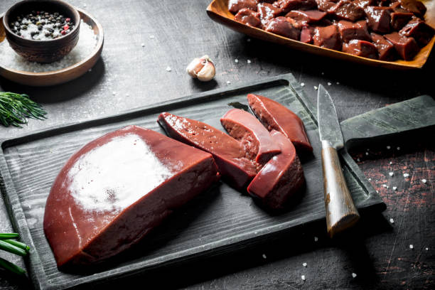 istock Sliced raw liver on a cutting Board with a knife. 1155952706