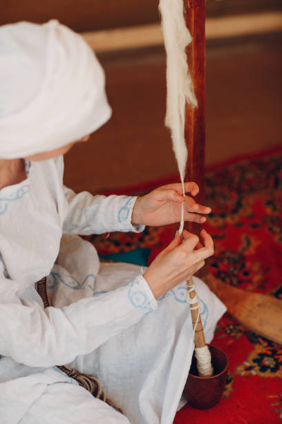 istock Woman makes thread, yarn and fabric 1155955567