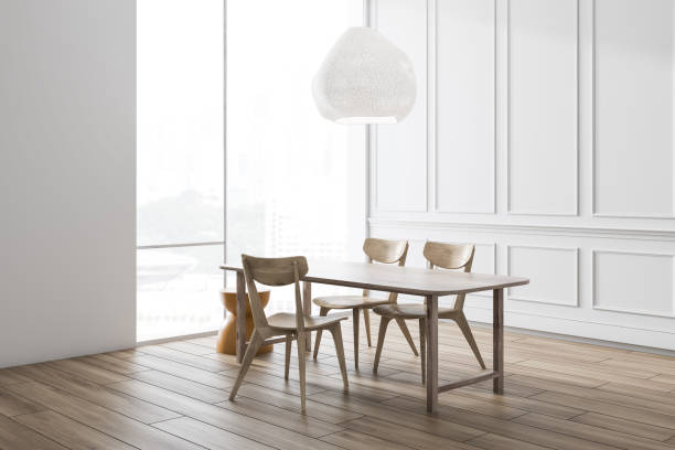 istock White dining room corner with wooden table 1155955964