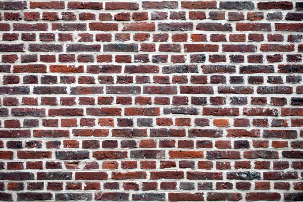 istock Multicolor wall of red and brown bricks. Texture background 1155956873