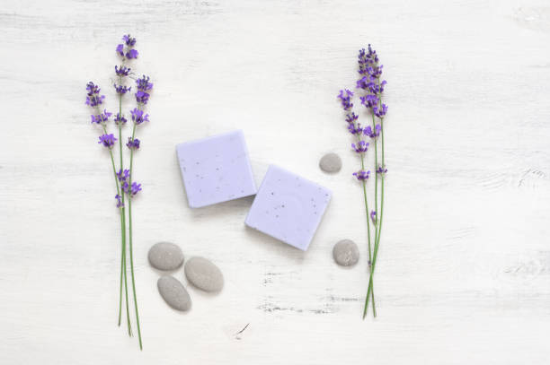 istock Lavender soap and flowers on rustic white wood 1155957082
