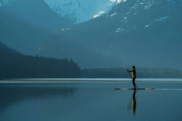 Photo of Single woman exploring natures beauty by paddleboard