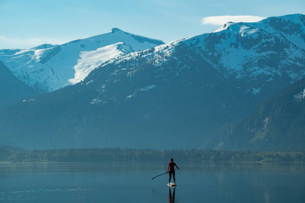 Single woman exploring natures beauty by paddleboard