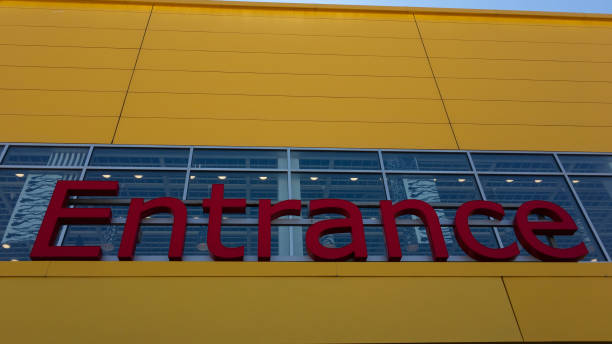 istock Entrance Sign on a Yellow storefront building 1155961775