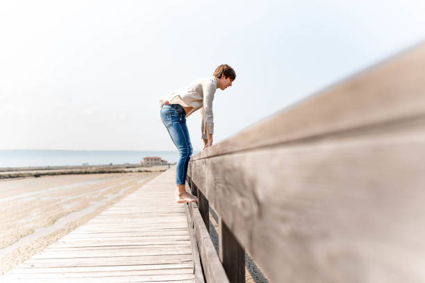 istock Young man standing on a wooden fence 1155961918