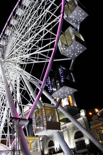 istock Ferris wheel glowing with light bulbs on dark night background similar. 1155962575