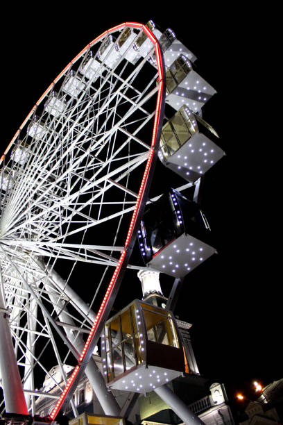 istock Ferris wheel glowing with light bulbs on dark night background similar. 1155962605