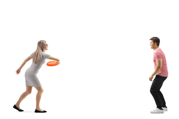 istock Young man and woman playing with a frisbee 1155962900