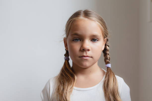 istock Cute girl looking at camera in a comfortable home 1155965048