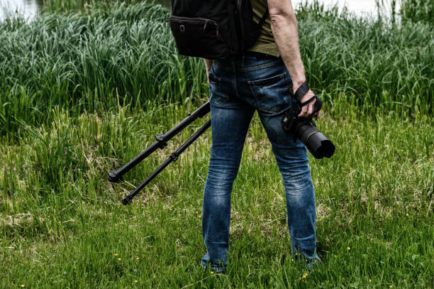 istock Photographer with camera and tripod. 1155967876