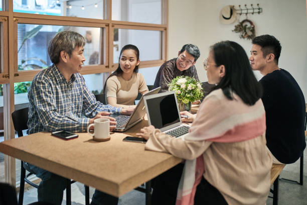 istock Asian Coworkers Brainstorming in Flex Office Space 1155971126