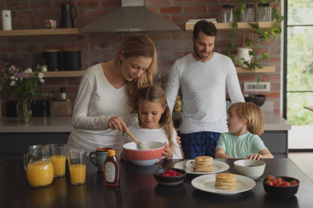 istock Family preparing food on worktop in kitchen 1155972514