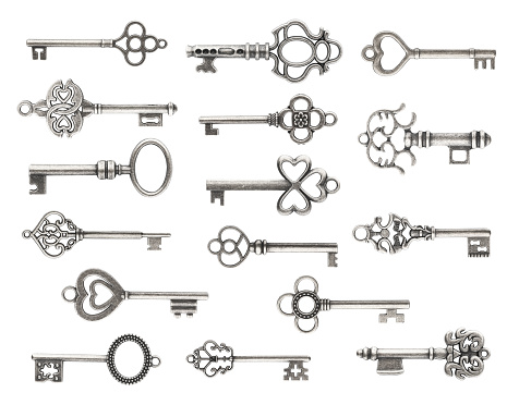 Old bronze keys, white background with copy space, full frame horizontal composition
