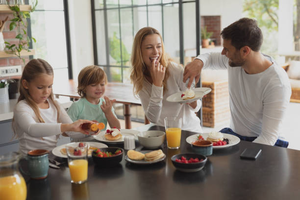 istock Caucasian family having food at dining table 1155972842