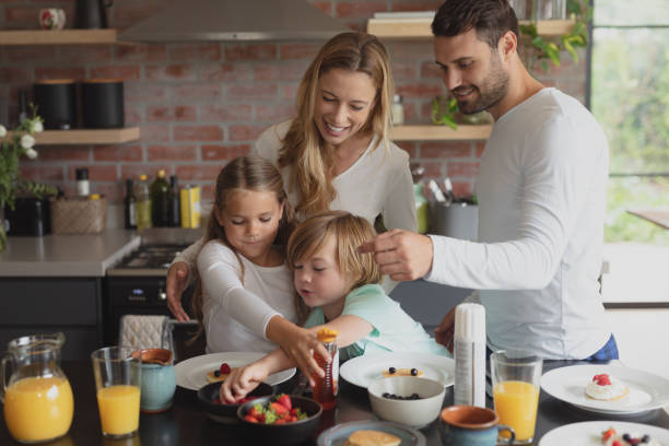 istock Caucasian family having food at dining table 1155972915