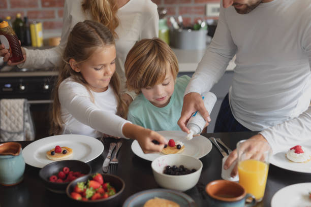 istock Caucasian family having food at dining table 1155972947