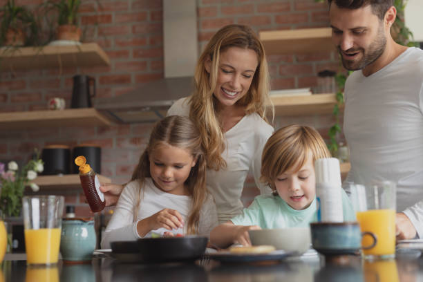 istock Caucasian family having food at dining table 1155973514