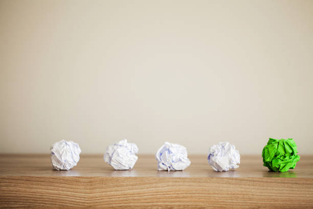 istock Great idea concept. Crumpled colorful paper on wooden table. Copy space 1155973981
