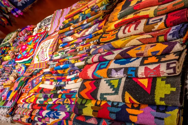 Photo of Peruvian traditional colourful native handicraft textile fabric at market in Peru