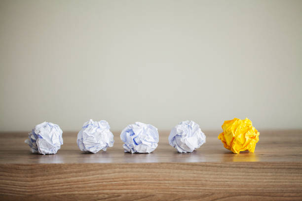 istock Creative idea concept. Crumpled paper balls on wood background 1155974542