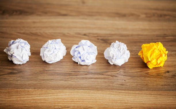 istock Great idea concept. Crumpled colorful paper on wooden table. Copy space 1155974558