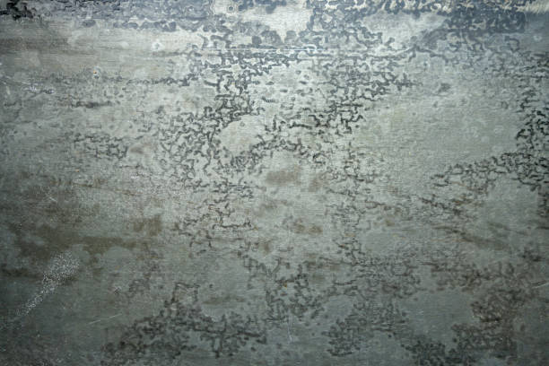 Detailed close-up view of galvanized metal surface with a diagonal brushed pattern and crystalline zinc coating. Ideal for backgrounds, textures, and industrial design concepts.