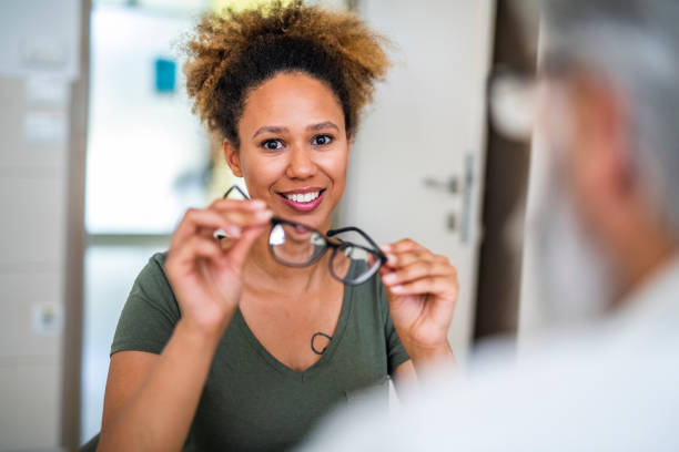 istock Woman testing out her new eyeglasses in ophthalmology office 1155976020