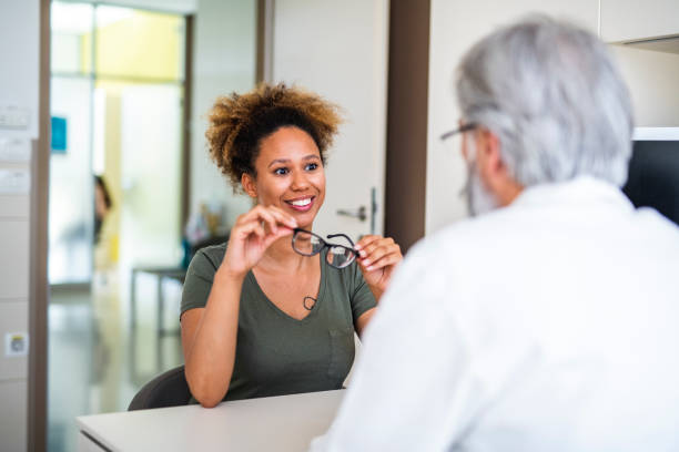 istock Woman testing out her new eyeglasses in ophthalmology office 1155976021