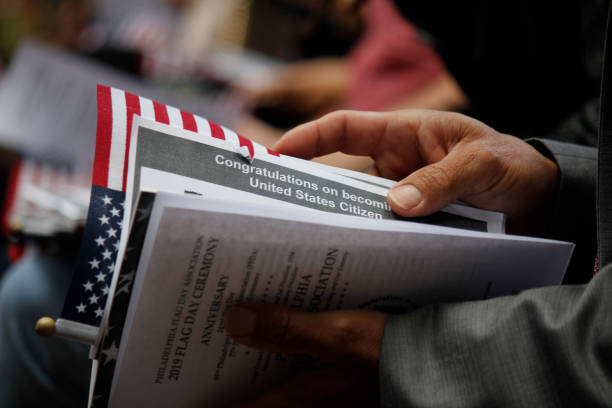 Thirteen immigrants become naturalized United States citizens on Flag Day Philadelphia, PA, USA - June 14, 2019: Thirteen immigrants from 12 different countries become new U.S. citizens in a special naturalization ceremony on Flag Day at the historic Betsy Ross House in Philadelphia, Pennsylvania."n"n human interest stock pictures, royalty-free photos & images