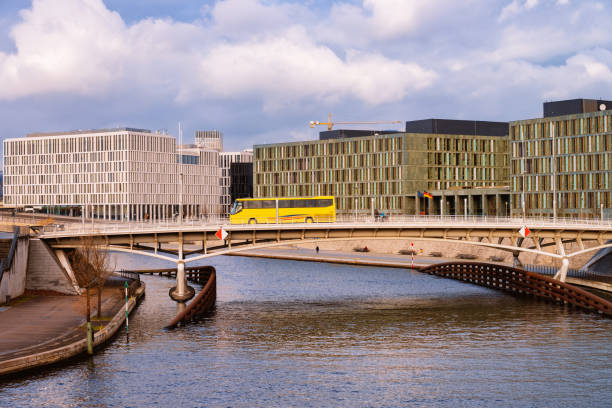 istock Cityscape with yellow bus in Berlin Mitte with Spree Riverfront 1155978809