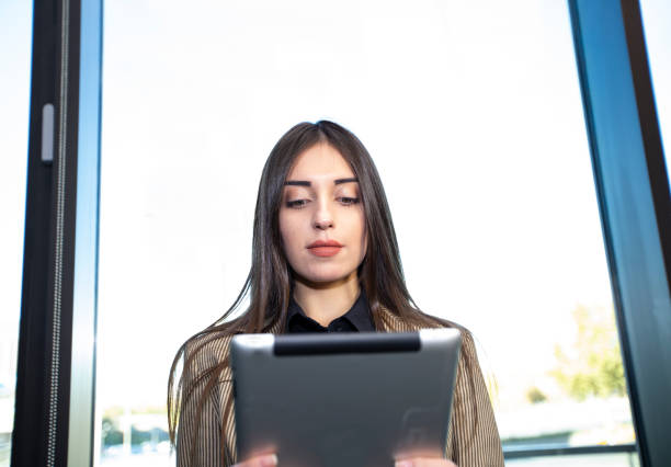 istock Beautiful business woman working with computer tablet 1155980764