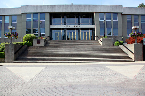 Front entrance of New Westminster BC City Hall.  Modernism Architecture built in 1953. Totally symmetrical design built of marble,concrete,sandstone.  Original Brass  door frames still intact.