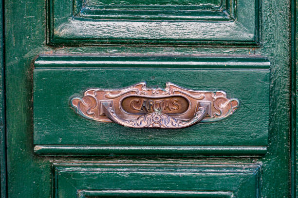 istock Typical Spanish Copper Mailbox on wooden green door 1155982728