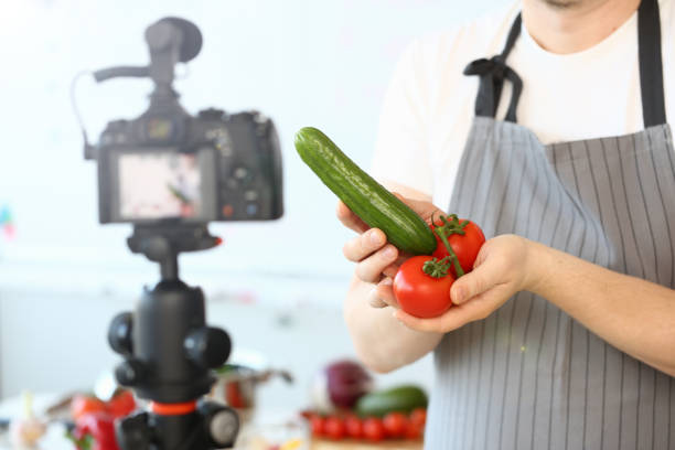 istock Comic Culinary Blogger Holding Organic Vegetables 1155986625