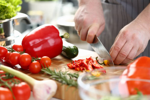 istock Professional Culinary Man Cutting Hot Chili Pepper 1155986637