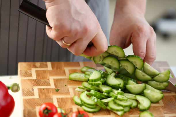 istock Culinary Male Chopping Green Dieting Cucumber 1155986638