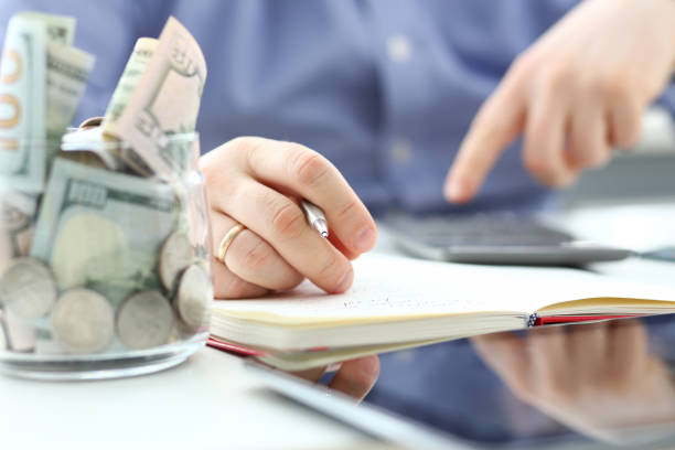 istock Male hand using calculator counting financial expenses 1155986691