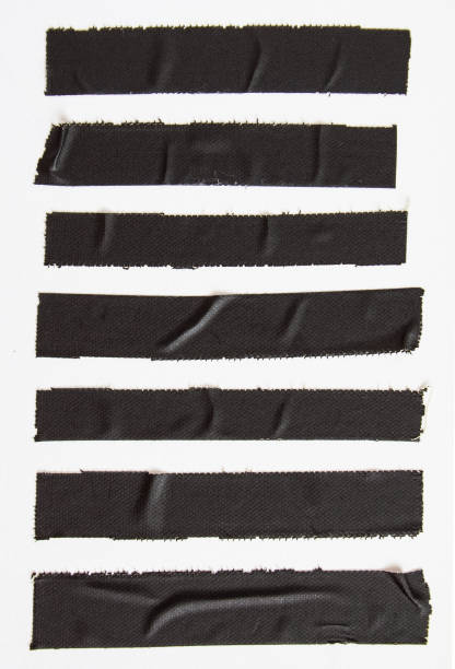 crumpled pieces of black matte cloth gaffer tape on white paper background. - matte imagens e fotografias de stock